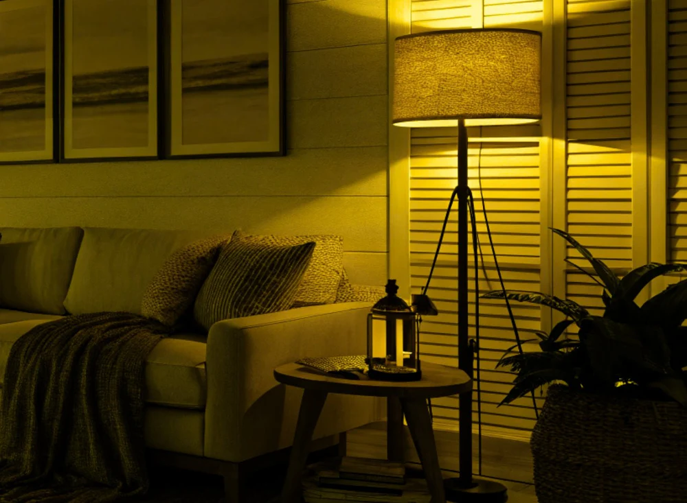 Soft amber lamp by a window at dusk